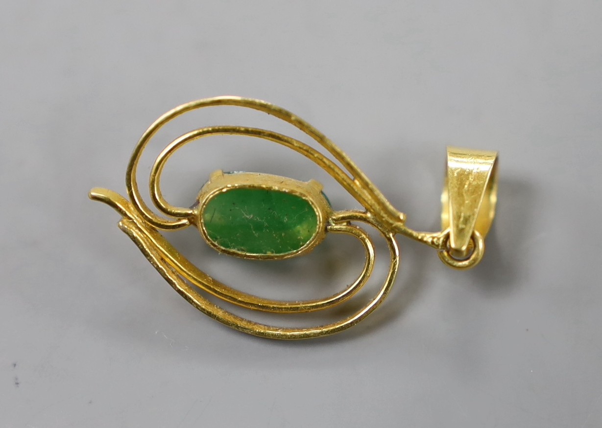 A yellow metal and single stone cabochon jade mounted pendant, overall 31mm, gross weight 2.2 grams.